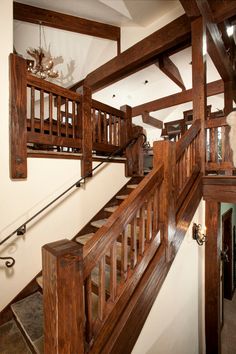 the stairs are made of wood and have wooden balconies