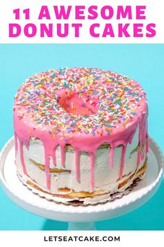 a cake with pink frosting and sprinkles on top, sitting on a plate