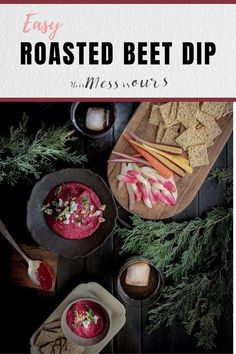 two bowls filled with beet dip next to crackers and vegetables