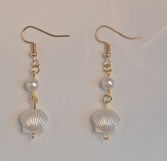 Dangle, pearl ,shell , gold ,earing , for summer vacation, white Elegant Pearl White Shell For Beach, Summer Pearl Earrings For Pierced Ears, Summer Pearl Earrings, Elegant White Shell For Beach, Dangle Shell Earrings With Pearl Drop, Dangle Pearl Drop Shell Earrings, Pearl Shell Drop Earrings With Pearl Drop Detail, Elegant Shell Dangle Earrings, Pearl Drop Dangle Shell