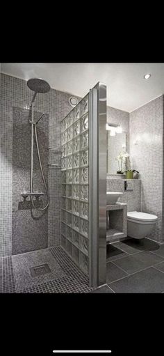 a bathroom with a shower, toilet and sink in it's stall door area