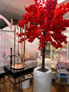 a room filled with furniture and a red tree