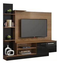 an entertainment center with a flat screen tv mounted on it's side and shelves