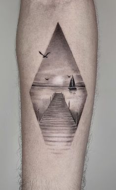 a man's leg with a black and white tattoo on it