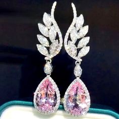 A delightfully unique pair of wedding earrings for the unconventional bride! The flawlessly faceted cubic zirconia stones capture the light in a dazzling array of sparkles, while the delicate drops add an extra touch of femininity. The earrings are rhodium plated for a bright finish which enhances the intricate detailing and conveys a modern take on classic elegance. Length: 1.8" (approx. 4.5cm); Width: 0.4" (approx. 1cm); Weight: 4g/earring. Available with Pink and Clear stones. To make your ch Cubic Zirconia Bridal Earrings, Wedding Earrings Drop, Sapphire Wedding, Pink Jewelry, Wing Earrings, Trendy Earrings, Crystal Drop Earrings, Copper Earrings, Pink Diamond