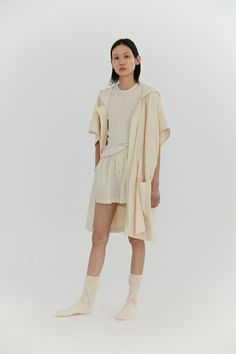 Our signature oversized robe features a short kimono-esque sleeve, ample hood and belted drawstring to be worn loose or synched around the waist. The above knee length and short sleeves gives you the perfect amount of coverage to lounge around in or go about your activities without feeling weighed down. Made in organic cotton imported from Portugal, this double faced knit features a luxurious brushed exterior and a quick absorbing terry loop interior. *Due to the delicacy of this fabric, the tex Chic Summer Outerwear For Loungewear, Casual Oversized Robe For Loungewear, Beige Short Sleeve Summer Outerwear, Oversized Summer Loungewear Outerwear, Short Sleeve Summer Outerwear For Beach, Terry Robe, Hooded Robe, Short Kimono, Above Knee