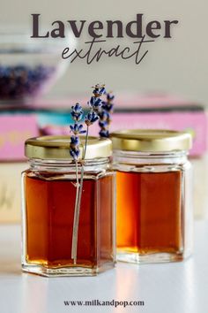 two jars filled with honey sitting on top of a table