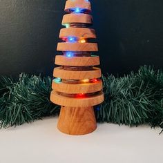 a wooden christmas tree with multi colored lights