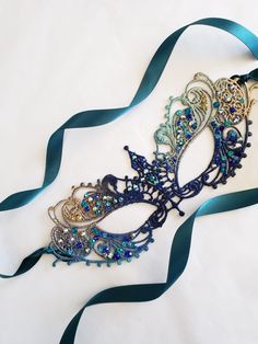 We offer original handcrafted embellishment designs for your mask. We can customize any mask to create a wearable work of art unique to you!This Masquerade Mask is made with beautiful notes of Blue turquoise Teal navy... Inspired by the deep blue ocean theme this Lace mask will leave you feeling like a mermaid at your ball or party!  Handcrafted lightweight original lace mask with hand-placed rhinestones or custom painted to match your outfit.  Mask Colors   -1st pic shows the Blue/teal/Gold the Masquerade Mask Women, Elegant Face Mask, Masquerade Ball Masks, Couples Masquerade Masks, Masquerade Outfit, The Mask Costume, Masquerade Ball Mask, Silver Mask, Lace Crowns