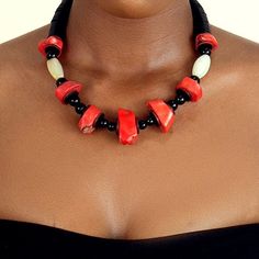 This necklace is handmade with large real coral beads. Once reserved for the nobility of great kingdoms such as the Benin Empire, coral beads are a symbol of royalty and wealth. These earth tone vintage beads add a regal touch to any look. Artisan Red Coral Beaded Necklaces With Gemstone Beads, Traditional Red Coral Beaded Necklace, Traditional Beaded Necklace With Red Coral And Natural Stones, Unique Red Coral Beaded Necklaces With Large Beads, Red Coral Beaded Necklaces, Red Coral Beaded Necklaces With Wooden Beads, Red Coral Beaded Necklaces With Large Beads, Red Coral Jewelry With Wooden Beads, Red Coral Necklace With Wooden Beads