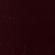 a dark red leather textured background or wallpaper that looks like it could be used as a backdrop