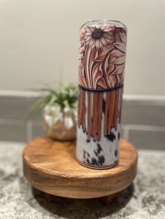 a vase sitting on top of a wooden stand