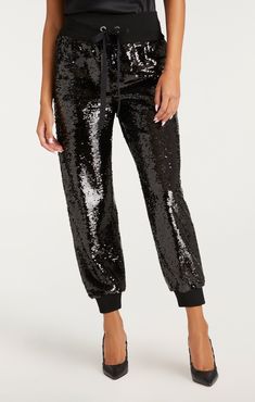 Transform your look with the Sequin Giles Pant. These cropped pants feature a drawstring and elastic waist and cuffs for a comfortable fit, along with sequin accents and pockets for a touch of glamour. Details Pull on styleFabric: SequinElasticized at waist and anklesMid-rise Cropped length Content and Care 100% PolyesterDry Clean Only Imported Measurements 26in/66.04cm inseamMeasurements from size S Fitted High-waisted Sequin Pants, Luxury Sequined High-waisted Pants, Chic Full-length Sequined Pants, Luxury Black Sequined Pants, Luxury High-waisted Sequin Pants, Skirt Coverup, Short Denim Skirt, Evening Tops, Denim Outerwear