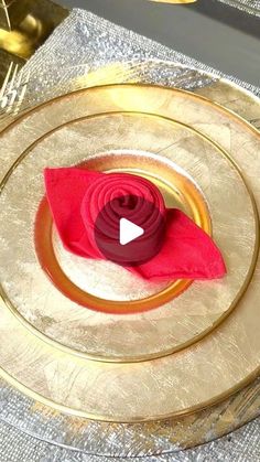 a gold plate with a red flower on it