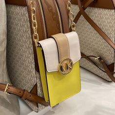 Michael Kors Carmen Small Color-Block Faux Leather Phone Crossbody Bag Sunshn Color: Sunshine Multi / Yellow Crossbody Bag Faux Saffiano Leather 88.92% Coated Canvas/11.08% Polyester Trim: 100% Polyurethane Gold-Tone Hardware 4.25”W X 7”H X 1.25”D Interior Details: 3 Card Slots Lining: 100% Polyester Snap Fastening Imported Yellow Phone Bag With Removable Pouch As Shoulder Bag, Yellow Crossbody Phone Bag With Adjustable Strap, Yellow Travel Crossbody Phone Bag, Yellow Crossbody Phone Bag For Travel, Yellow Phone Bag With Adjustable Strap For Travel, Yellow Michael Kors Travel Bag, Yellow Crossbody Bag With Cell Phone Pocket, Yellow Crossbody Shoulder Bag With Phone Pocket, Yellow Crossbody Shoulder Bag With Mobile Phone Pocket