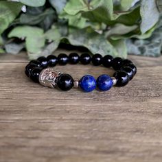 Materials: 8mm Genuine Natural Gemstone Beads * Lapis Lazuli * Black Onyx * Silver Buddha and Disk Spacers * Elasticated Bracelet w/Stretch Cord LAPIS LAZULI: Calming. BLACK ONYX: Protection. Add a gift box to your order: https://www.satorigemboutique.com/shop/26142361/gift-box Visit our shop policy and FAQ page for care instructions: https://www.satorigemboutique.com/policy * Wearing gemstones can help wearers carry a sense of peace, calm, mindfulness and focus with them throughout the day. We Spiritual Lapis Lazuli Round Beads Bracelets, Lapis Lazuli Bracelets For Meditation, Adjustable Lapis Lazuli Bracelet With Round Beads, Elegant 8mm Beads Bracelet For Meditation, Adjustable Polished Beads Bracelets For Meditation, Spiritual 8mm Beads Wristband, Adjustable Lapis Lazuli Bracelet With 8mm Beads, Gift Lapis Lazuli Round Bead Bracelets, Gift Lapis Lazuli Bracelets With Round Beads