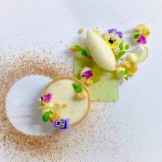 two desserts on a plate with sprinkles and flowers in the middle