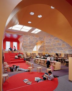 people are sitting and standing in the library