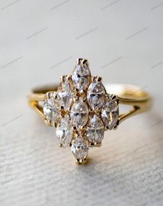 an antique diamond cluster ring in yellow gold