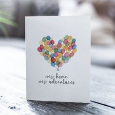 there is a card with balloons in the shape of a heart that says new home, new adventures