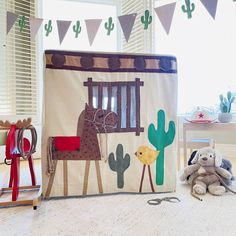 a stuffed animal sitting next to a canvas bag with an image of a giraffe