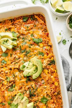 an enchilada casserole with avocado and cilantro