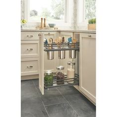 an open cabinet in a kitchen with pots and pans on the bottom shelf,