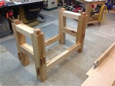 two wooden stools sitting on top of a workbench