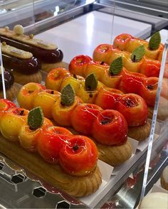 many different types of pastries on display in a glass case