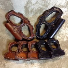 four different types of leather hand grips on a table