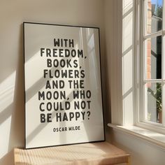 there is a poster on the wall next to a window that says, with freedom books flowers and the moon who could not be happy?