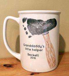 a white coffee mug with the words grandaddy's little helper on it