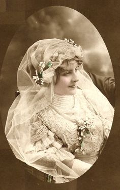 an old photo of a woman wearing a veil