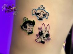 three cartoon tattoos on the side of a woman's stomach