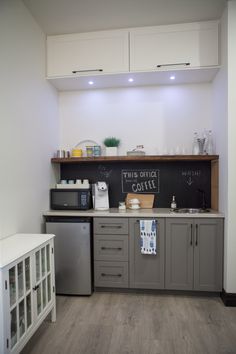 a small kitchen with a chalkboard on the wall