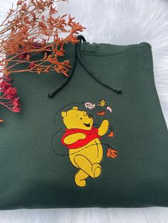 Winnie The Pooh Embroidered Sweatshirt, Fall Season Embroidery, Halloween Sweatshirt, Vintage Cozy Autumn Sweatshirt, Back To School Sweater 🍯 Embrace cozy fall vibes with this Winnie the Pooh Halloween-themed sweatshirt. Featuring Pooh in a festive autumn design, it's the perfect blend of warmth and whimsy for the season. Ideal for fans who love both comfort and a touch of Halloween fun. The design I've used in the primary picture is a Forest Green Sweatshirt, please select your own selection Hooded Top With Custom Embroidery For Fall, Crew Neck Hoodie With Machine Embroidery For Fall, Fall Custom Embroidered Hooded Top, Green Hoodie With Letter Embroidery For Fall, Fall Custom Embroidery Hoodie Tops, Fall Hoodie With Crew Neck And Machine Embroidery, Green Embroidered Fall Hoodie, Fall Crew Neck Hoodie With Machine Embroidery, Green Long Sleeve Sweatshirt With Machine Embroidery