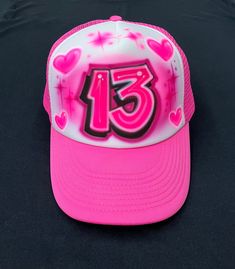 Airbrushed SnapBack Trucker Hat with your choice of lettering and color scheme.  Hats are made with a white polyester foam front and colored mesh back with a one size fits most snap enclosure. Pink Trucker Hat With Letter Print, Personalized Pink Snapback Trucker Hat, White Hip Hop Trucker Hat With Letter Print, Personalized Flat Bill Trucker Hat, Personalized Trucker Hat One Size Fits Most, Custom White Snapback Hat, Custom White Snapback Cap, Personalized Pink Trucker Hat, White Snapback Baseball Cap For Birthday