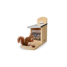 a toy squirrel is sitting in a wooden house