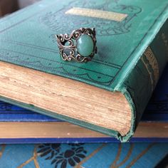 Victorian style filigree ring measuring 18mm wide at the widest point and fully adjustable. Choose antiqued silver or antiqued brass. In the center is a 10x8mm oval aventurine cabochon. Aventurine is medium green with a metallic iridescence caused by fuchsite (green mica) inclusions. The look of the stone you receive may vary slightly from the one pictured. I do not recommend wearing this jewelry while bathing or swimming although simple hand washing is fine. Be sure to search my shop for other Irish Jewelry Rings, Aventurine Ring, Victorian Accessories, Green Aventurine Stone, Fan Jewelry, Aventurine Stone, Accesories Jewelry, Irish Jewelry, Filigree Ring