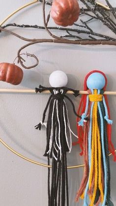 an assortment of beads hanging on a circular wall rack with hooks and balls attached to it