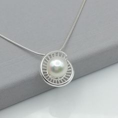 ▪︎ An elegant pendant made with a pearl on a sterling silver base. ▪︎ Size: 12 mm x 18 mm. Pearl size: 10mm Weighs: 3 gm ▪︎ This multi purpose pendant can be used as a charm in necklaces, bracelets, key chains, zip pullers etc. ▪︎ This pendant is handmade with hypoallergenic sterling silver. Most of my pieces are marked with a 925 silver stamp. ▪︎ Please note: This listing is for ONE pendant and comes WITHOUT the chain, however, you can add a snake chain in the required length while making your Ganesh Pendant, Egyptian Necklace, Silver Charm Necklace, Silver Eye, Charm Necklace Silver, Elegant Pendant, Locket Charms, Bohemian Necklace, Silver Lockets