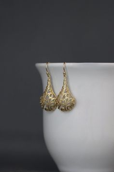 "Bold and detailed matte gold vermeil filigree charms simply dangle from gold vermeil balled earwires. These dramatic cut out charm earrings complete any outfit for daytime or evening. Gold charms: 19x32mm Total length of earrings: 1 3/4\" All gold is 18k gold vermeil. As the owner, maker, designer, and curator of this shop, I take great pride in providing you with jewelry that you will love to wear everyday, for special occasions, and for many years to come. Please read my Shop Policies which c Gold Filigree Sterling Silver Chandelier Earrings, Gold Sterling Silver Filigree Chandelier Earrings, Teardrop-shaped Gold Plated Filigree Jewelry, Gold Plated Filigree Teardrop Jewelry, Elegant Gold Chandelier Earrings, Elegant 14k Yellow Gold Chandelier Earrings, Elegant Filigree Dangle Jewelry, Elegant 14k Gold Pierced Chandelier Earrings, 14k Yellow Gold Earrings With Intricate Design