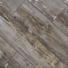 an old wood floor with peeling paint and chipping off the top, in grey tones