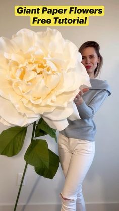 a woman standing next to a giant white flower with the text giant paper flowers free printable