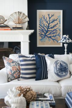 a living room filled with lots of pillows and decor on top of a white couch