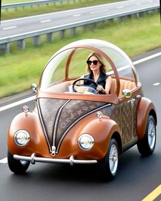 a woman driving an old fashioned car down the road