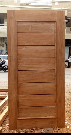 a large wooden door sitting on top of a pile of wood