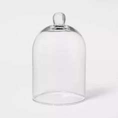 an empty glass bottle with a lid on a white background