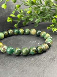 Do you like Jade stone? We have over 10 models in our Jade section.  Jade stone is found in several countries around the world and what makes this stone special is its unique diversity of colors from white to green and even bright orange. Description of this bracelet: - Round natural African jade stone beads +\- 8.5mm - On jewelry-quality stretch cord Bracelet length: 5.5 inches (Very very small) to 8.5 inches (Very very large) If you do not know your wrist diameter please refer to the explanato Casual Jade Bracelets With Gemstone Beads, Casual Jade Gemstone Beads Bracelets, Casual Jade Bracelet With Gemstone Beads, Casual Jade Bracelet With Natural Stones, Casual Green Agate Bracelets, Casual Green Agate Bracelet, Casual Green Crystal Bracelet For Healing, Casual Green Stretch Bracelet With Natural Stones, Green Round Beads Bracelet, Nature-inspired