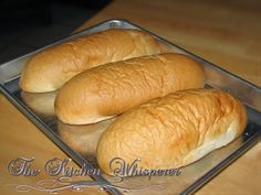 two loaves of bread sitting on top of a metal pan